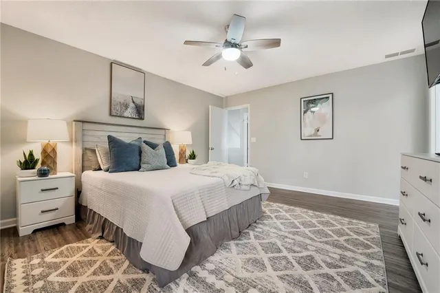 a bedroom with a large bed and a window