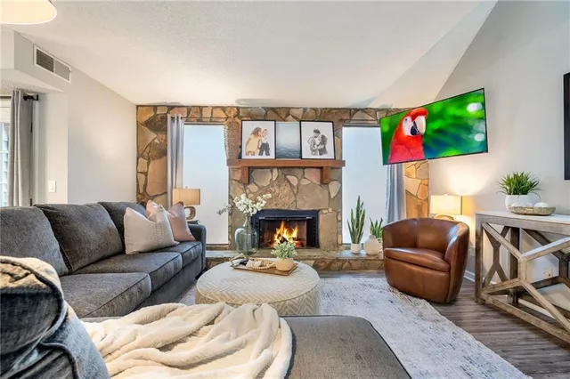 a living room with furniture and a fireplace