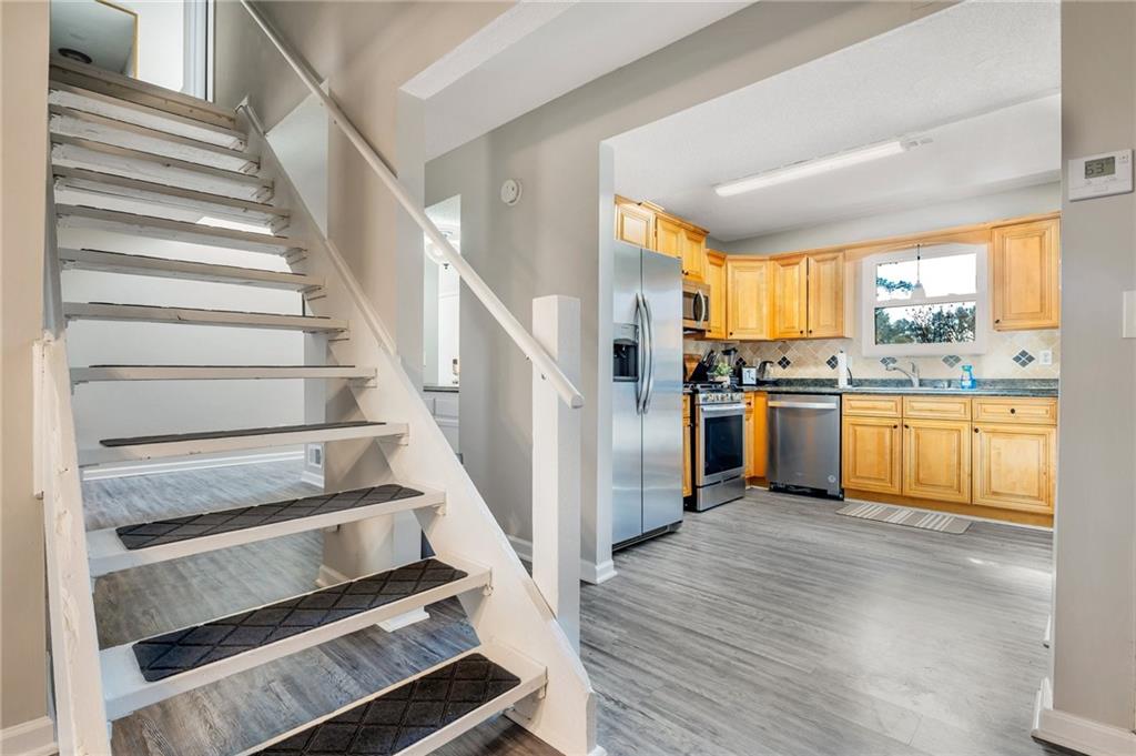 Undisclosed Address Marietta, GA 30064 - Photo 7 of 25 a view of kitchen with wooden floor and electronic appliances
