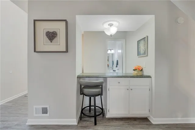 a view of cabinets with wooden floor and furniture