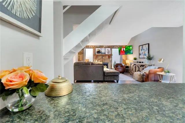 a living room with furniture a rug and a toilet