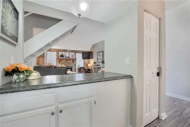 a kitchen with stainless steel appliances granite countertop a sink and a white cabinets