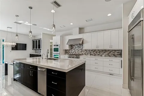 a bathroom with double vanity and a mirror