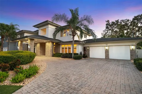 a living room with furniture a flat screen tv and a floor to ceiling window