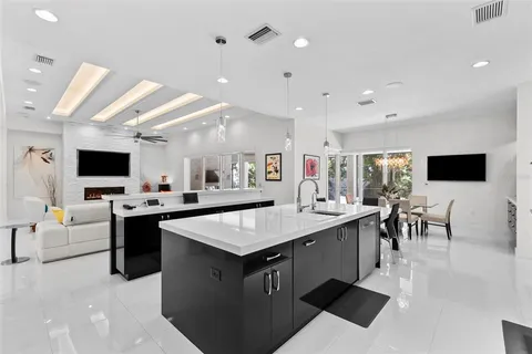 a spacious bedroom with a bed and a chandelier