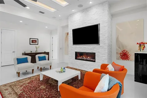 a living room with furniture fireplace and a flat screen tv