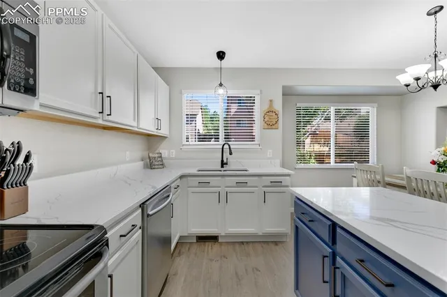 a kitchen with a sink stove and cabinets