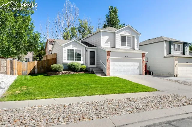 a front view of a house with a garden and plants