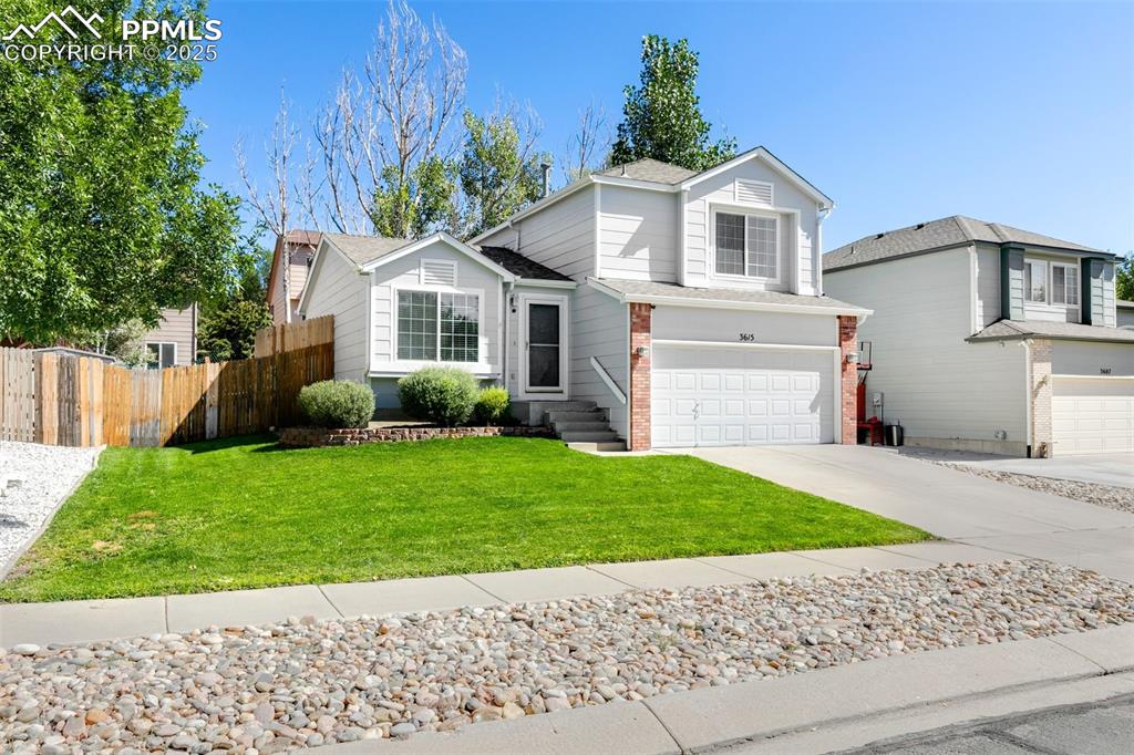 3615 Bareback Drive Colorado Springs, CO 80922 - Photo 2 of 27 a front view of a house with a garden and plants