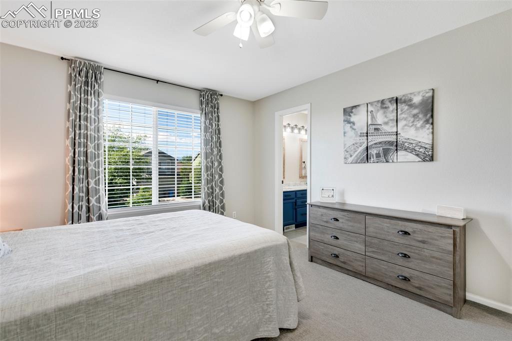 3615 Bareback Drive Colorado Springs, CO 80922 - Photo 21 of 27 a spacious bedroom with a bed and a window