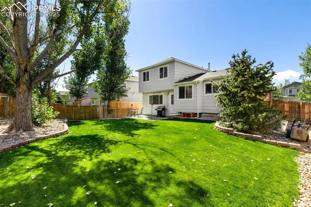 a view of house with backyard