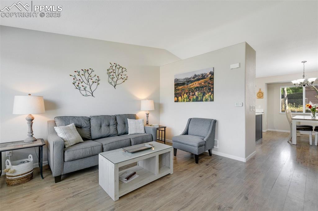 3615 Bareback Drive Colorado Springs, CO 80922 - Photo 3 of 27 a living room with furniture and a wooden floor