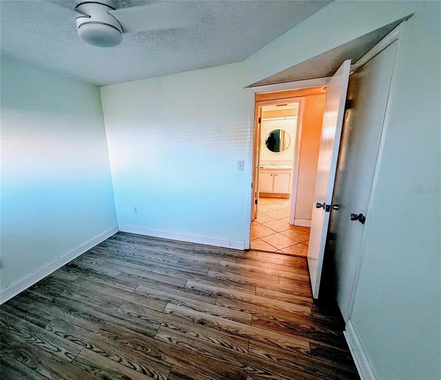 4775 Cove Circle, Unit 202 St. Petersburg, FL 33708 - Photo 12 of 19 a view of a hallway with wooden floor