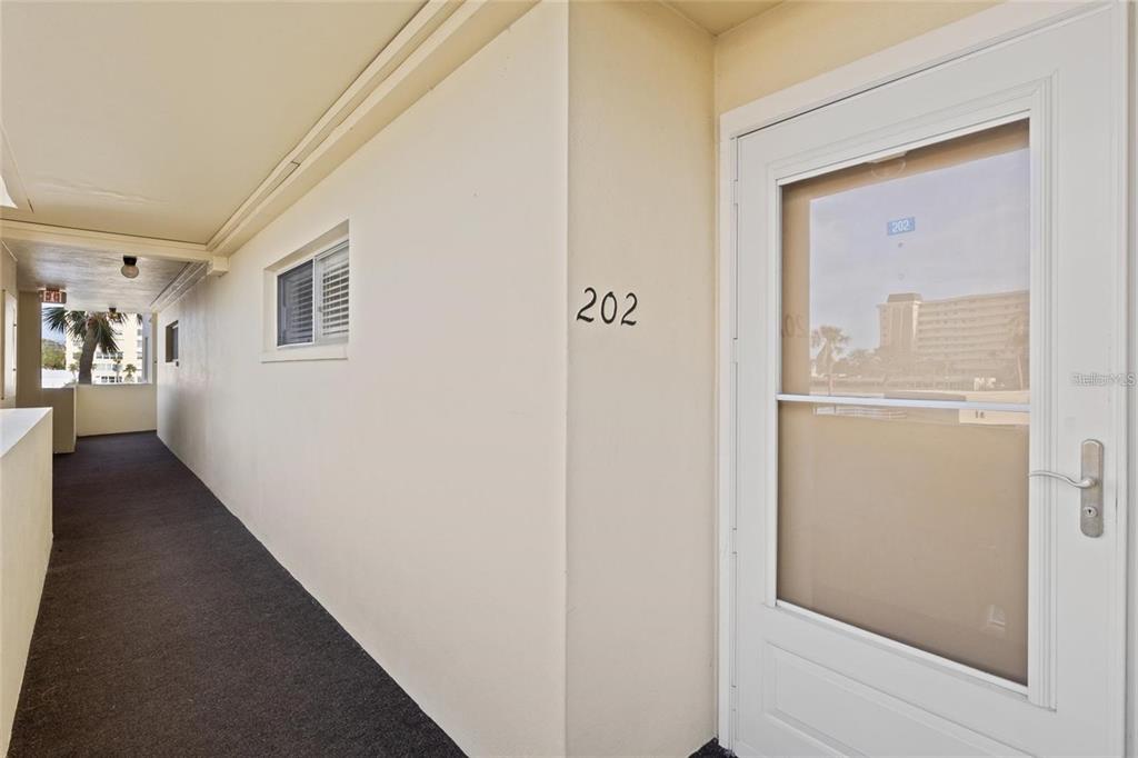 4775 Cove Circle, Unit 202 St. Petersburg, FL 33708 - Photo 4 of 19 a view of a hallway with wooden floor