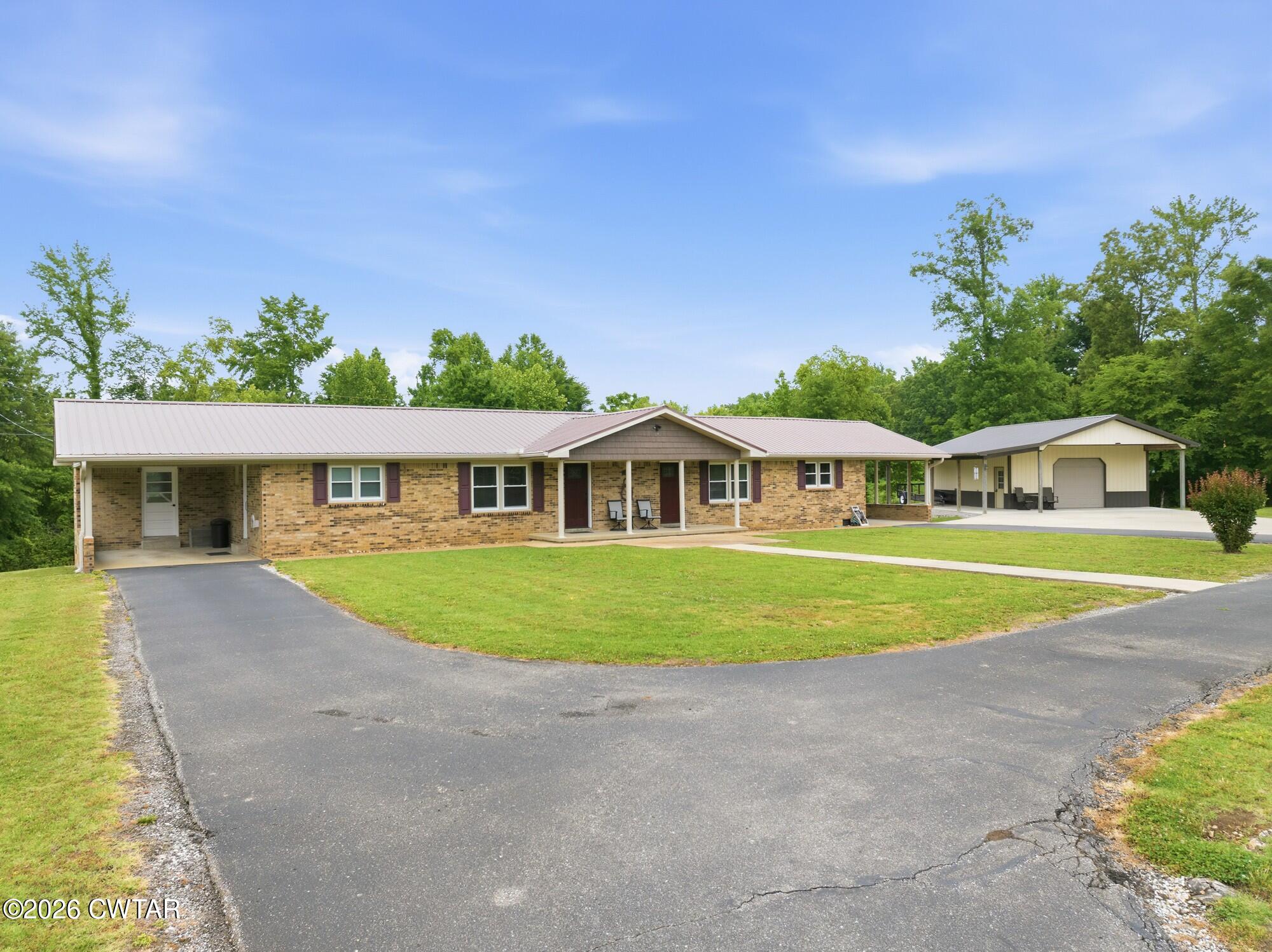 944 Brooksie Thompson Road Decaturville, TN 38329 - Photo 45 of 47 a front view of a house with a yard and trees
