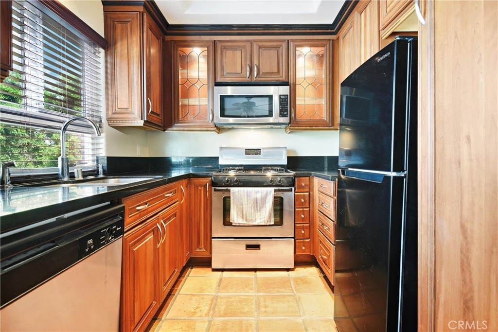 7267 Corbin Avenue, Unit M Winnetka, CA 91306 - Photo 11 of 28 a kitchen with granite countertop stainless steel appliances and cabinets
