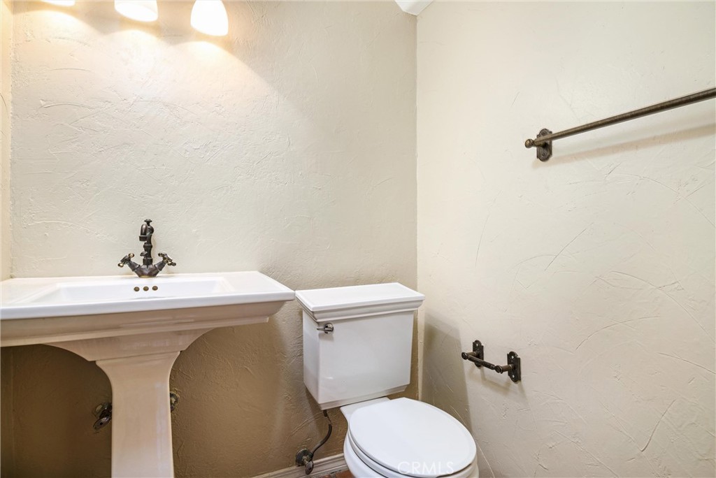 7267 Corbin Avenue, Unit M Winnetka, CA 91306 - Photo 12 of 28 a bathroom with a sink a toilet and mirror