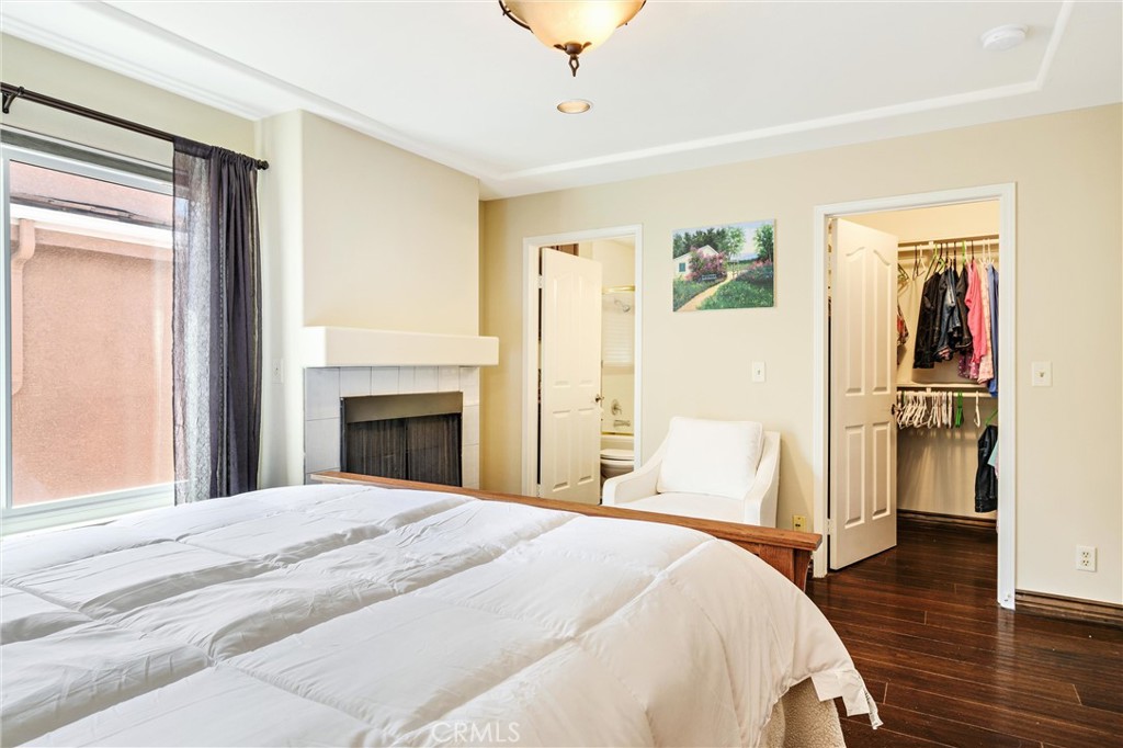 7267 Corbin Avenue, Unit M Winnetka, CA 91306 - Photo 13 of 28 a bedroom with a large bed and a chandelier