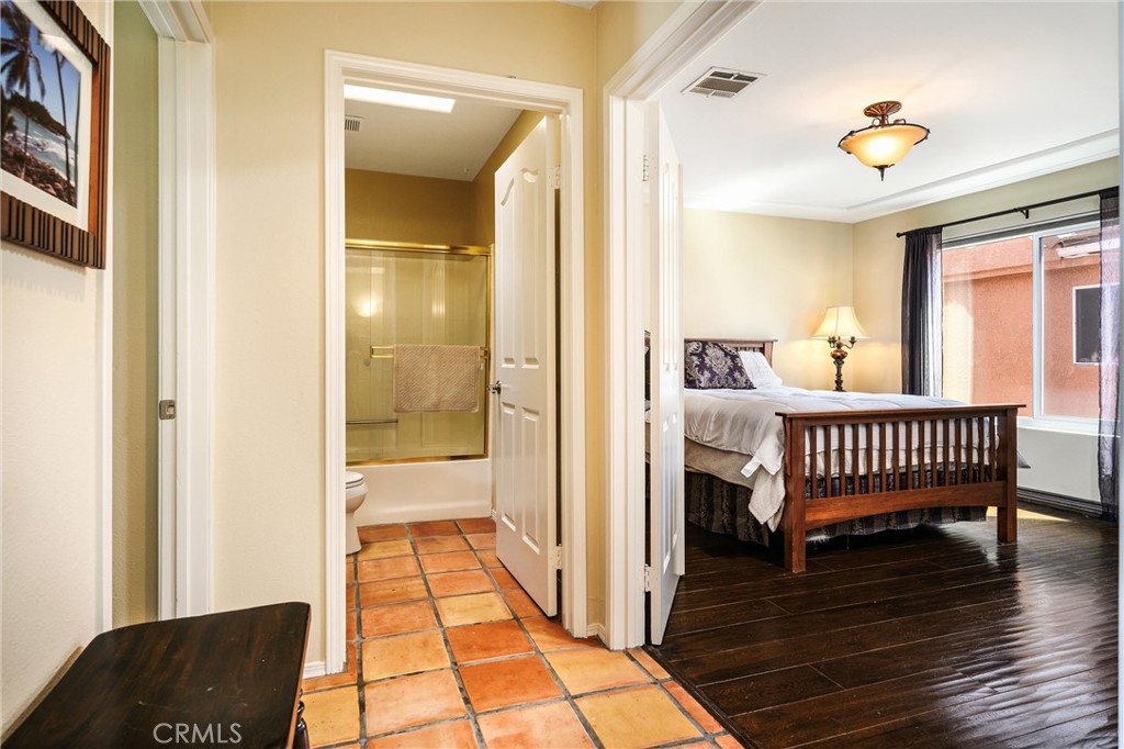 7267 Corbin Avenue, Unit M Winnetka, CA 91306 - Photo 14 of 28 a bedroom with a bed and wooden floor