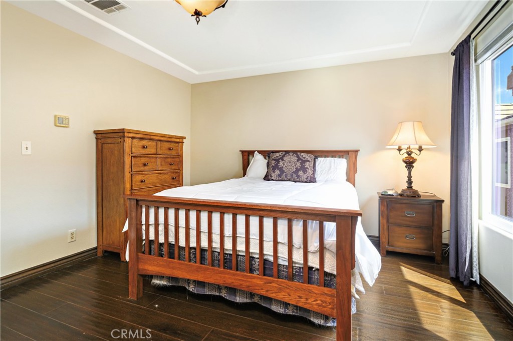 7267 Corbin Avenue, Unit M Winnetka, CA 91306 - Photo 17 of 28 a bedroom with a bed and wooden floor