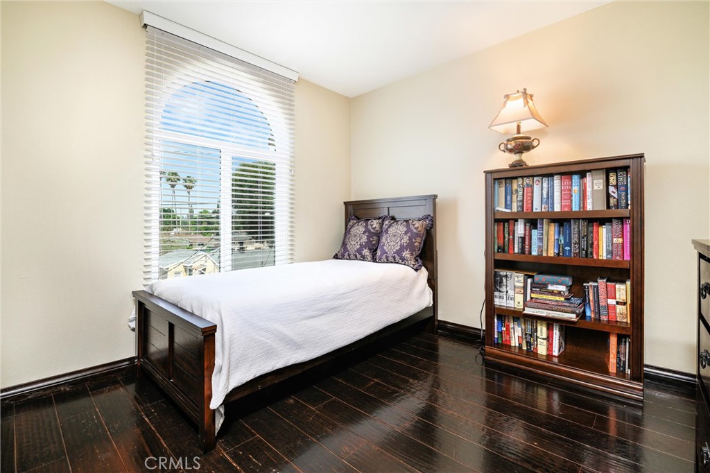 7267 Corbin Avenue, Unit M Winnetka, CA 91306 - Photo 18 of 28 a bed sitting in a bedroom next to a book shelf