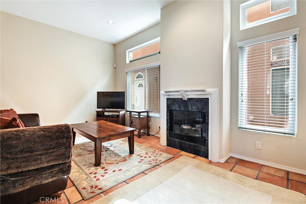 7267 Corbin Avenue, Unit M Winnetka, CA 91306 - Photo 2 of 28 a living room with furniture a flat screen tv and a fireplace