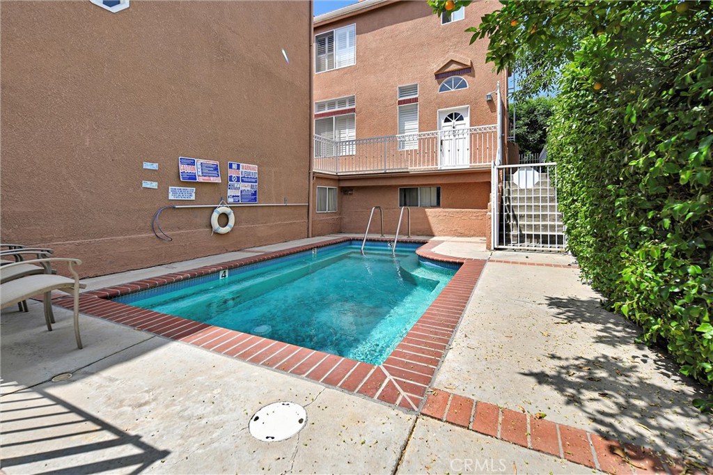 7267 Corbin Avenue, Unit M Winnetka, CA 91306 - Photo 27 of 28 a front view of a house with a yard
