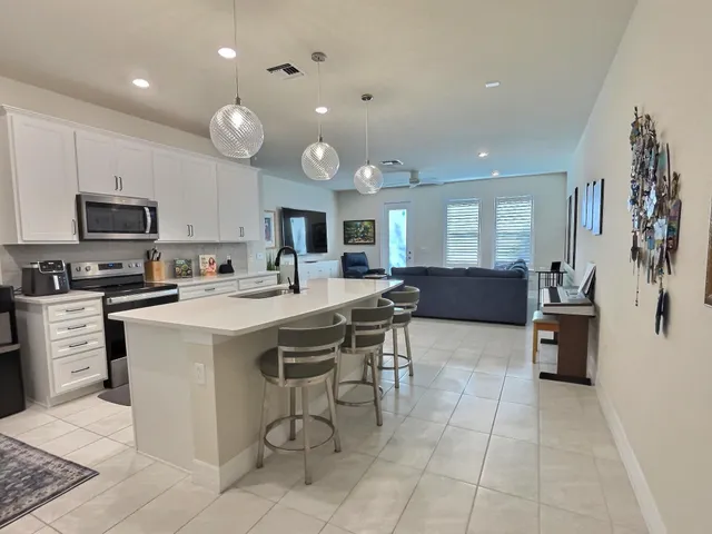 a large kitchen with a table and chairs in it