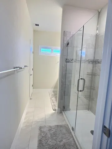 a bathroom with a glass shower door