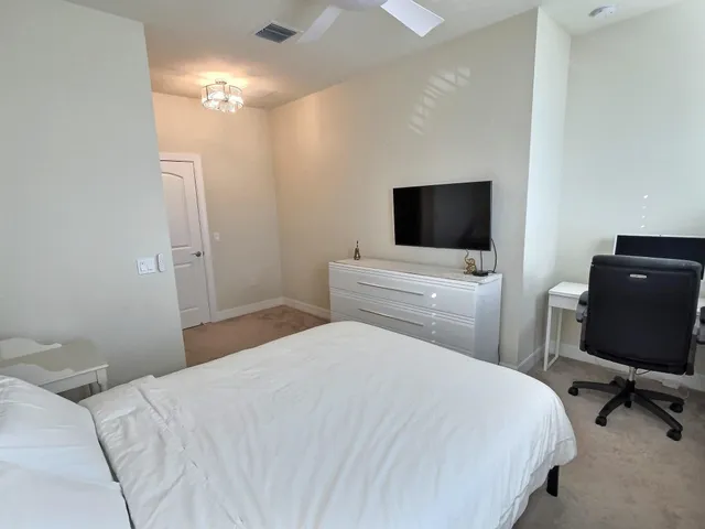 a bedroom with a bed and a flat screen tv