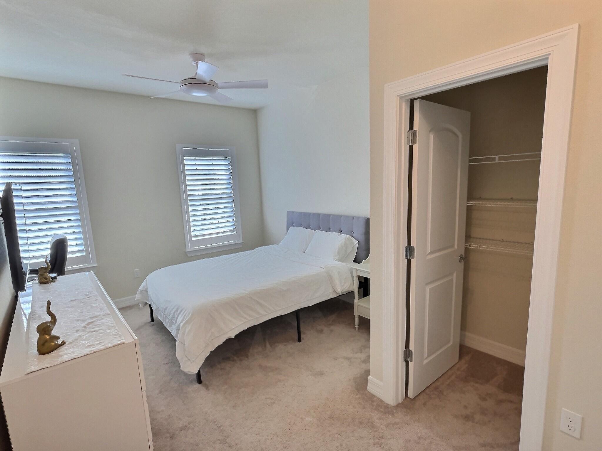 4829 Chantilly Road Lake Worth, FL 33467 - Photo 14 of 31 a bedroom with a bed and a window