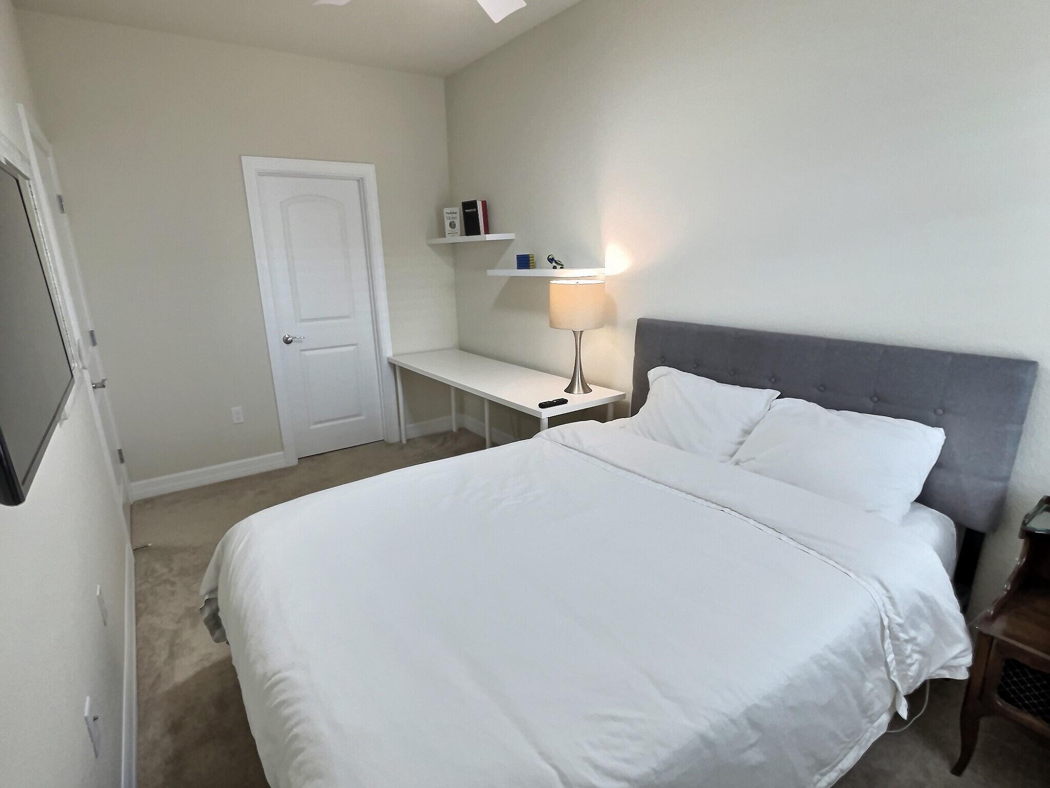 4829 Chantilly Road Lake Worth, FL 33467 - Photo 15 of 31 a bedroom with a bed and a night stand