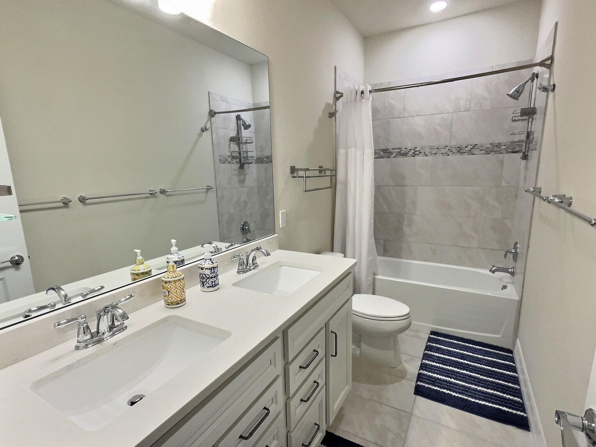 4829 Chantilly Road Lake Worth, FL 33467 - Photo 18 of 31 a bathroom with a sink a toilet and shower