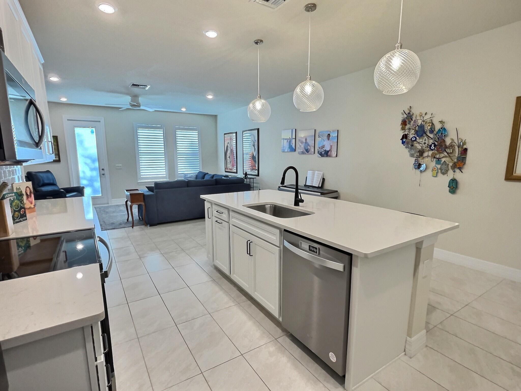 4829 Chantilly Road Lake Worth, FL 33467 - Photo 3 of 31 a kitchen with a sink a counter space appliances and cabinets