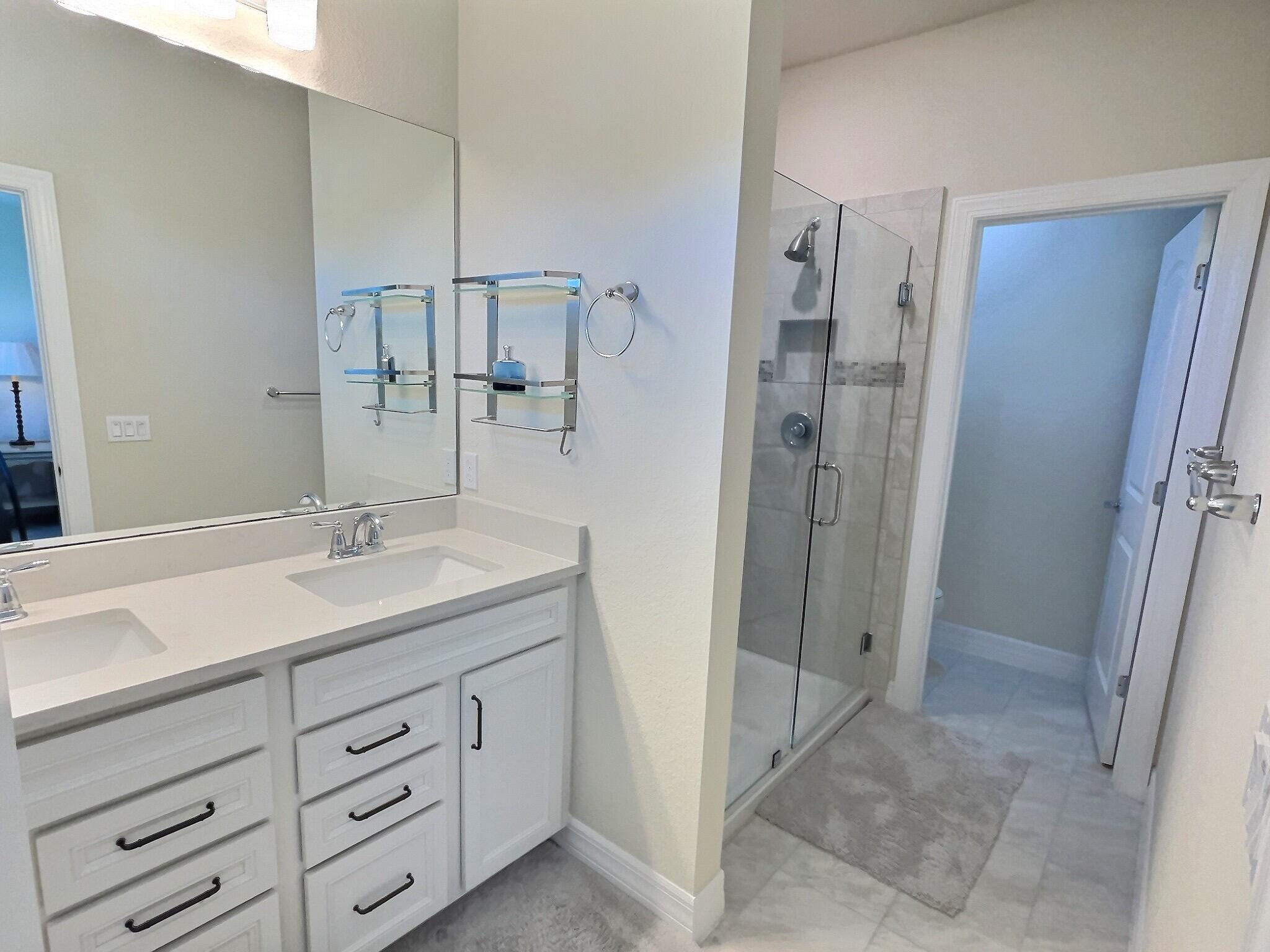 4829 Chantilly Road Lake Worth, FL 33467 - Photo 10 of 31 a bathroom with a shower sink and mirror