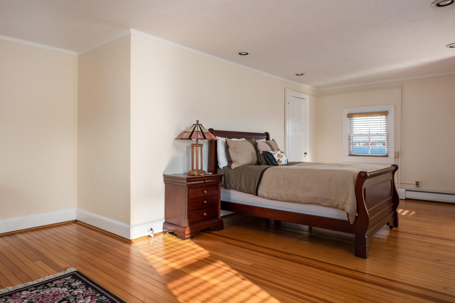 42 Robinwood Road Buzzards Bay, MA 02532 - Photo 23 of 39 a bedroom with a bed and wooden floor