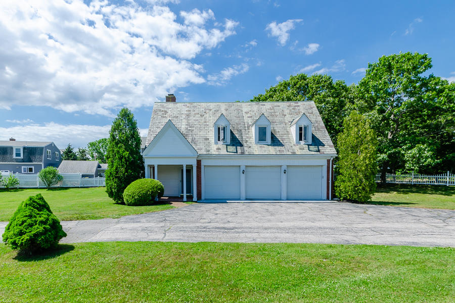 42 Robinwood Road Buzzards Bay, MA 02532 - Photo 7 of 39 a front view of a house with a garden and yard