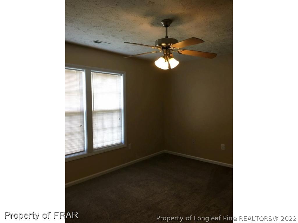 1065 Roundabout Road Cameron, NC 28326 - Photo 14 of 25 a view of a livingroom with a ceiling fan and window
