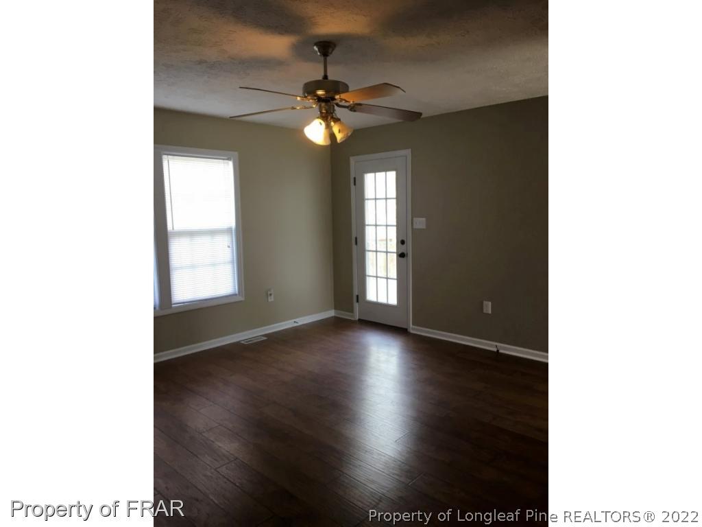 1065 Roundabout Road Cameron, NC 28326 - Photo 5 of 25 a view of a livingroom with a window and wooden floor