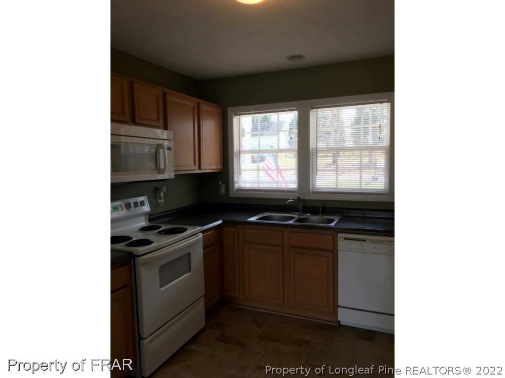 1065 Roundabout Road Cameron, NC 28326 - Photo 6 of 25 a kitchen with stainless steel appliances granite countertop a stove and a sink