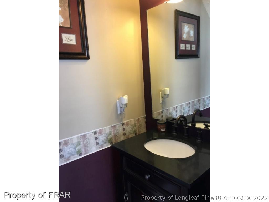 1065 Roundabout Road Cameron, NC 28326 - Photo 10 of 25 a bathroom with a sink and a mirror