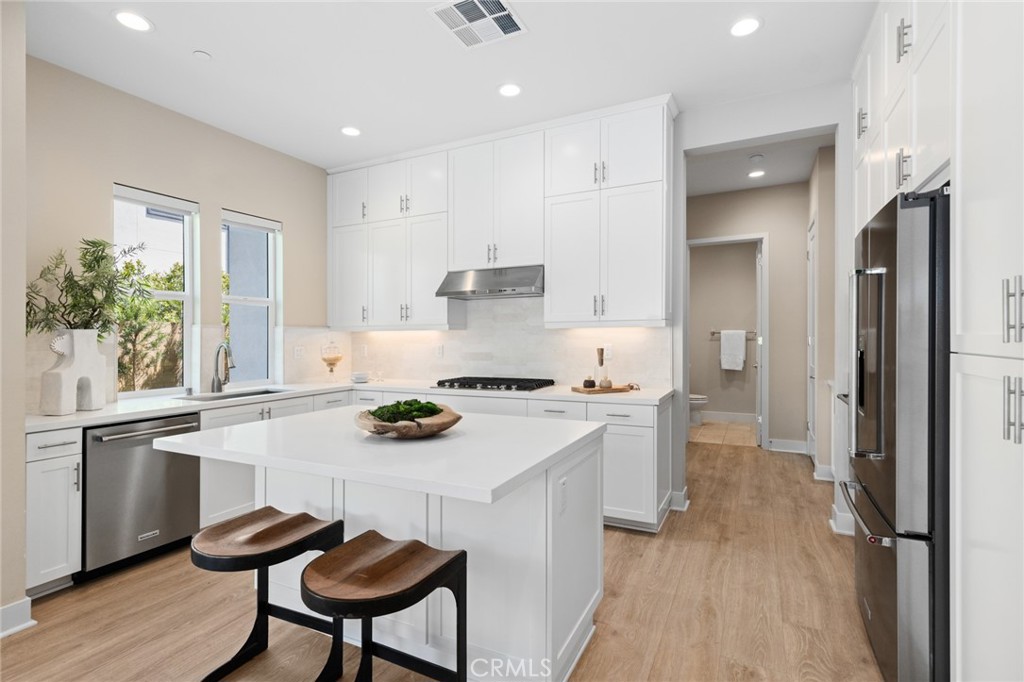 352 Novel Irvine, CA 92618 - Photo 11 of 75 a kitchen with stainless steel appliances a stove a sink cabinets and a refrigerator