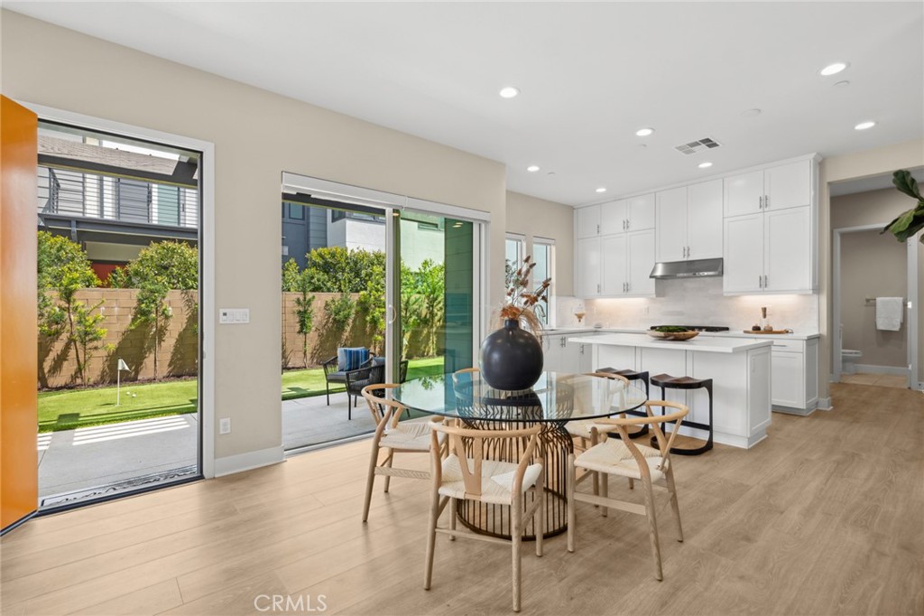 352 Novel Irvine, CA 92618 - Photo 17 of 75 a kitchen with a table chairs refrigerator and cabinets