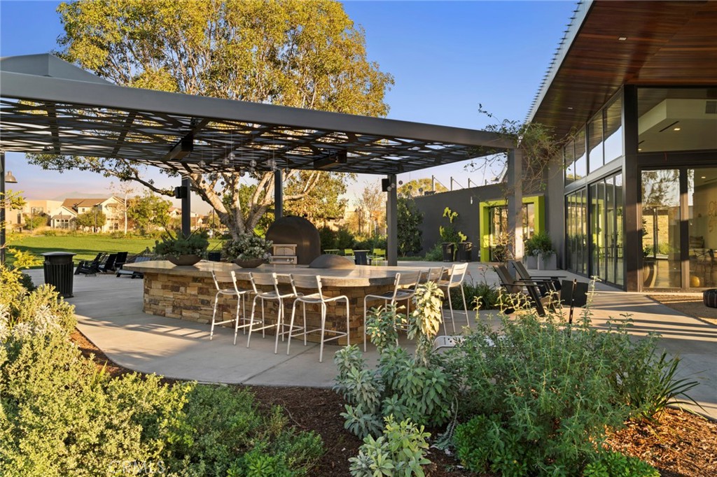 352 Novel Irvine, CA 92618 - Photo 55 of 75 a view of a patio with table and chairs potted plants and large tree