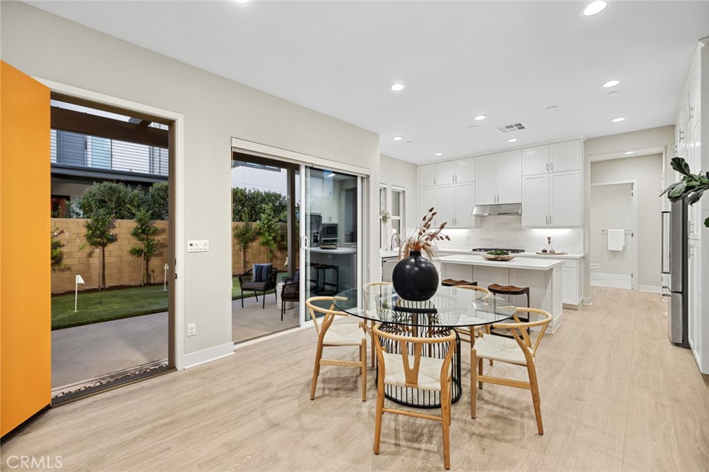 352 Novel Irvine, CA 92618 - Photo 7 of 75 a kitchen with a dining table chairs and refrigerator