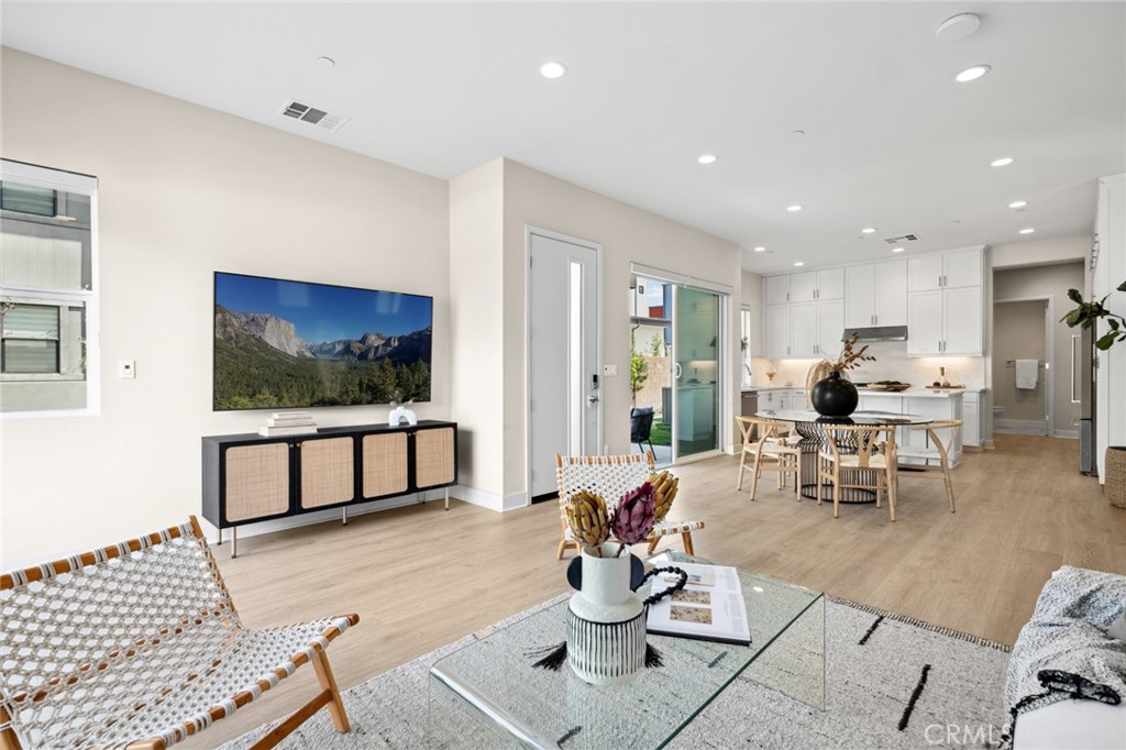 352 Novel Irvine, CA 92618 - Photo 9 of 75 a living room with furniture a flat screen tv and kitchen view