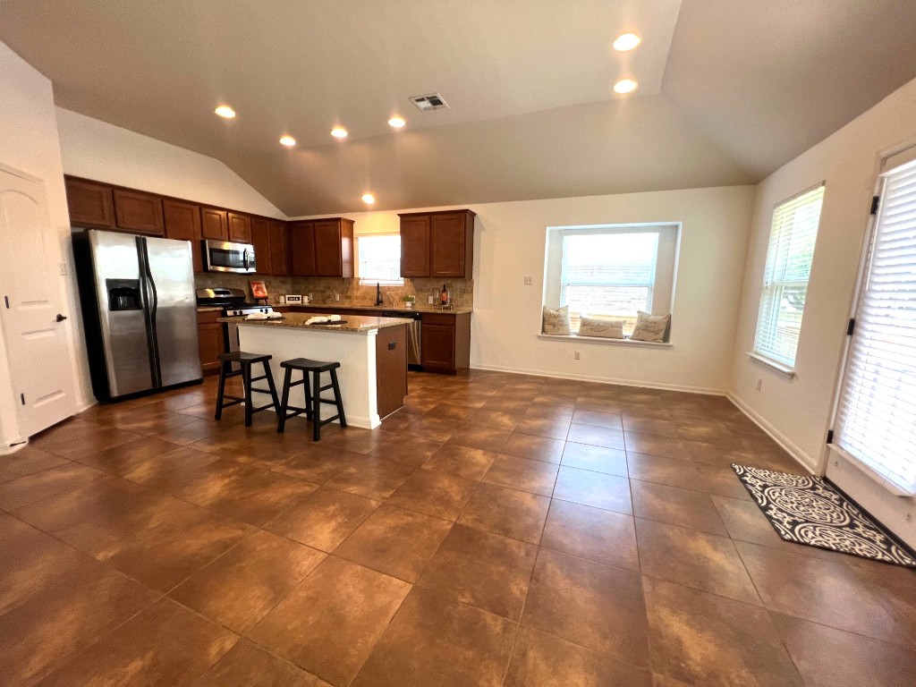 1711 Hidden Springs Path Round Rock, TX 78665 - Photo 10 of 39 a view of a kitchen with dining room and windows