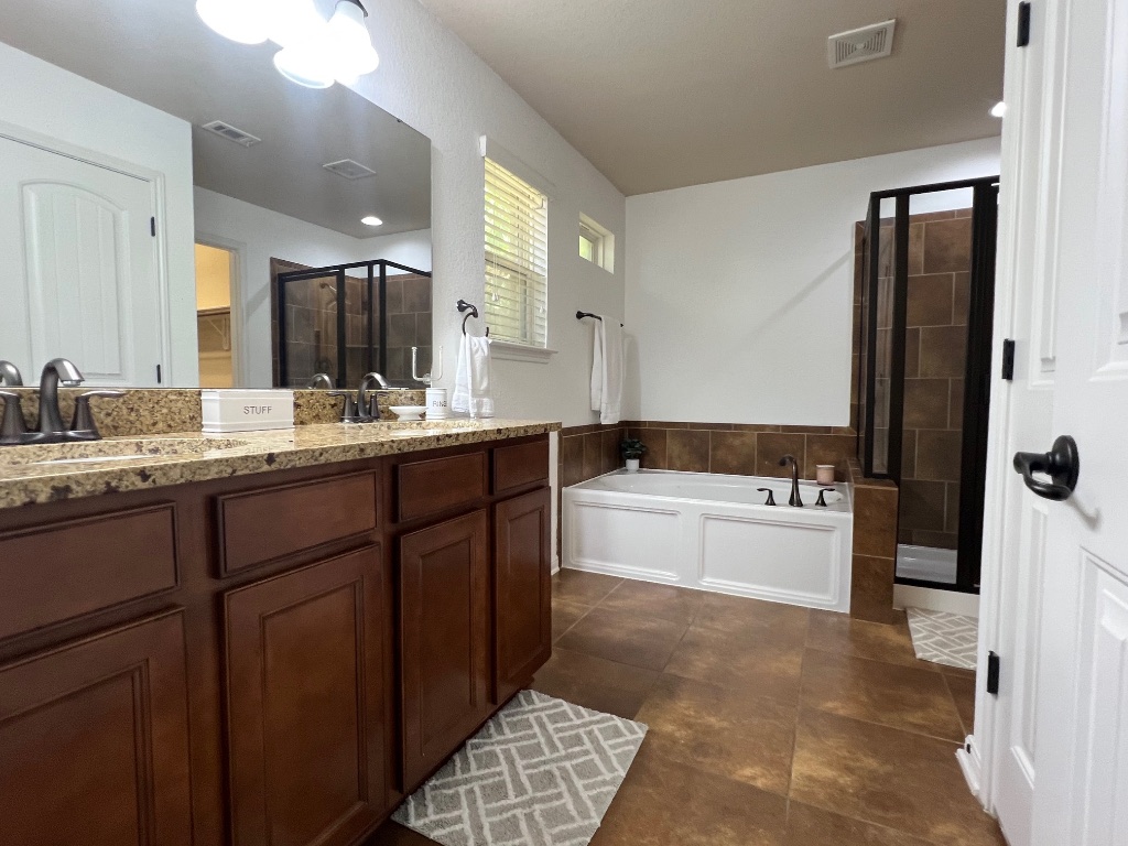 1711 Hidden Springs Path Round Rock, TX 78665 - Photo 17 of 39 a bathroom with a tub sink and mirror