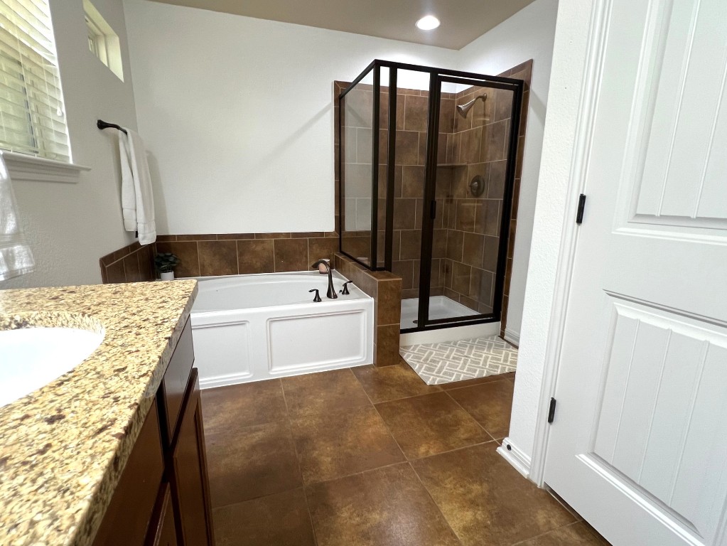 1711 Hidden Springs Path Round Rock, TX 78665 - Photo 18 of 39 a bathroom with a tub sink and shower
