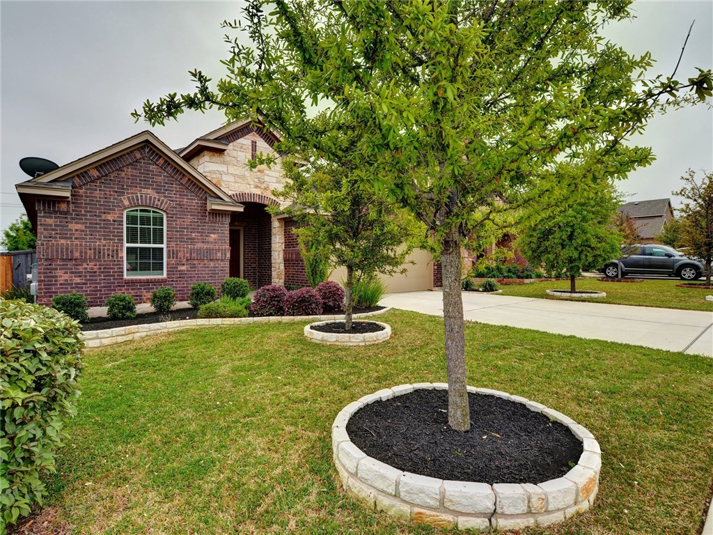 1711 Hidden Springs Path Round Rock, TX 78665 - Photo 2 of 39 a view of a house with backyard and sitting area